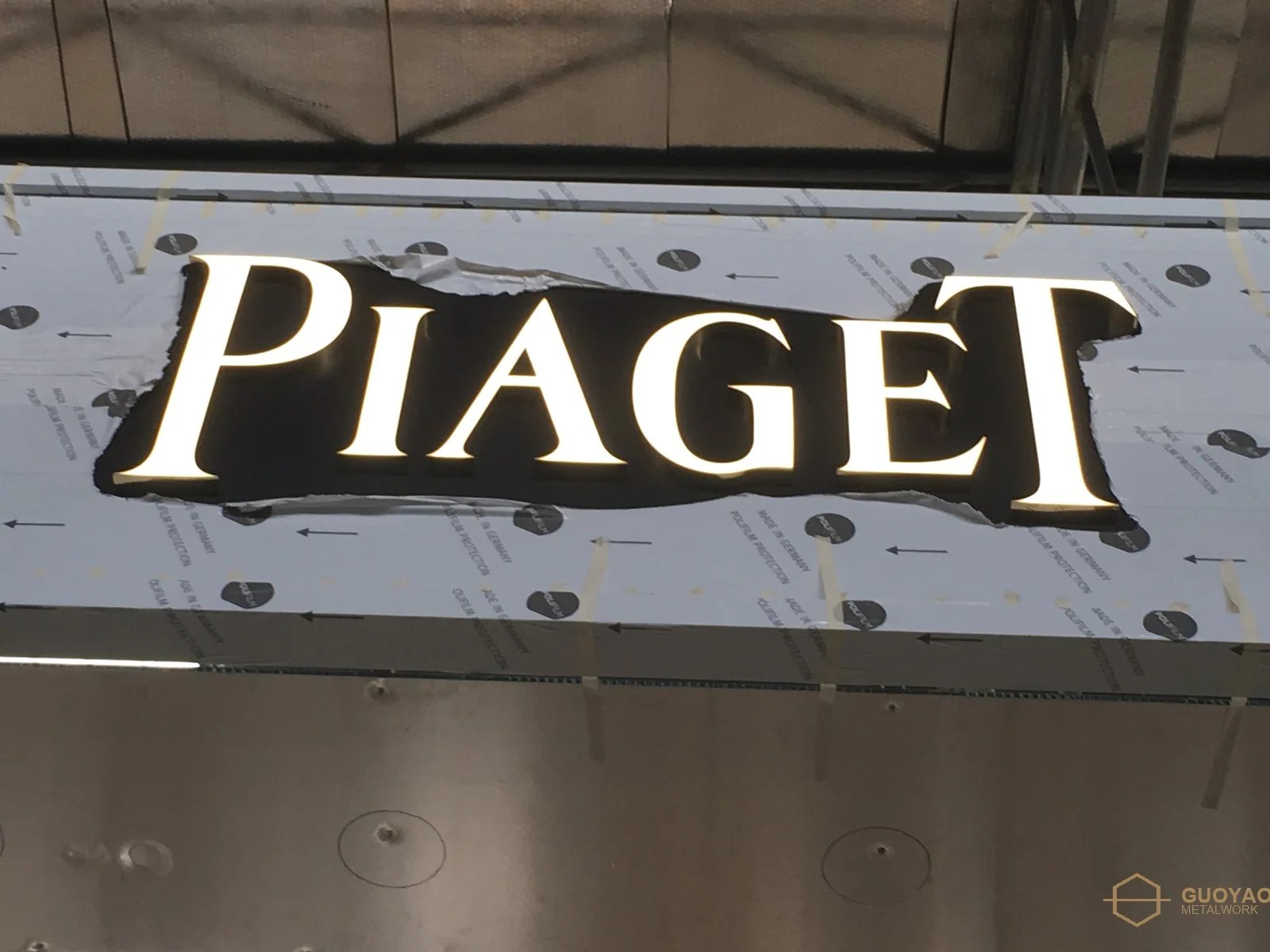 Backlit lettering detail on a boutique entrance portal