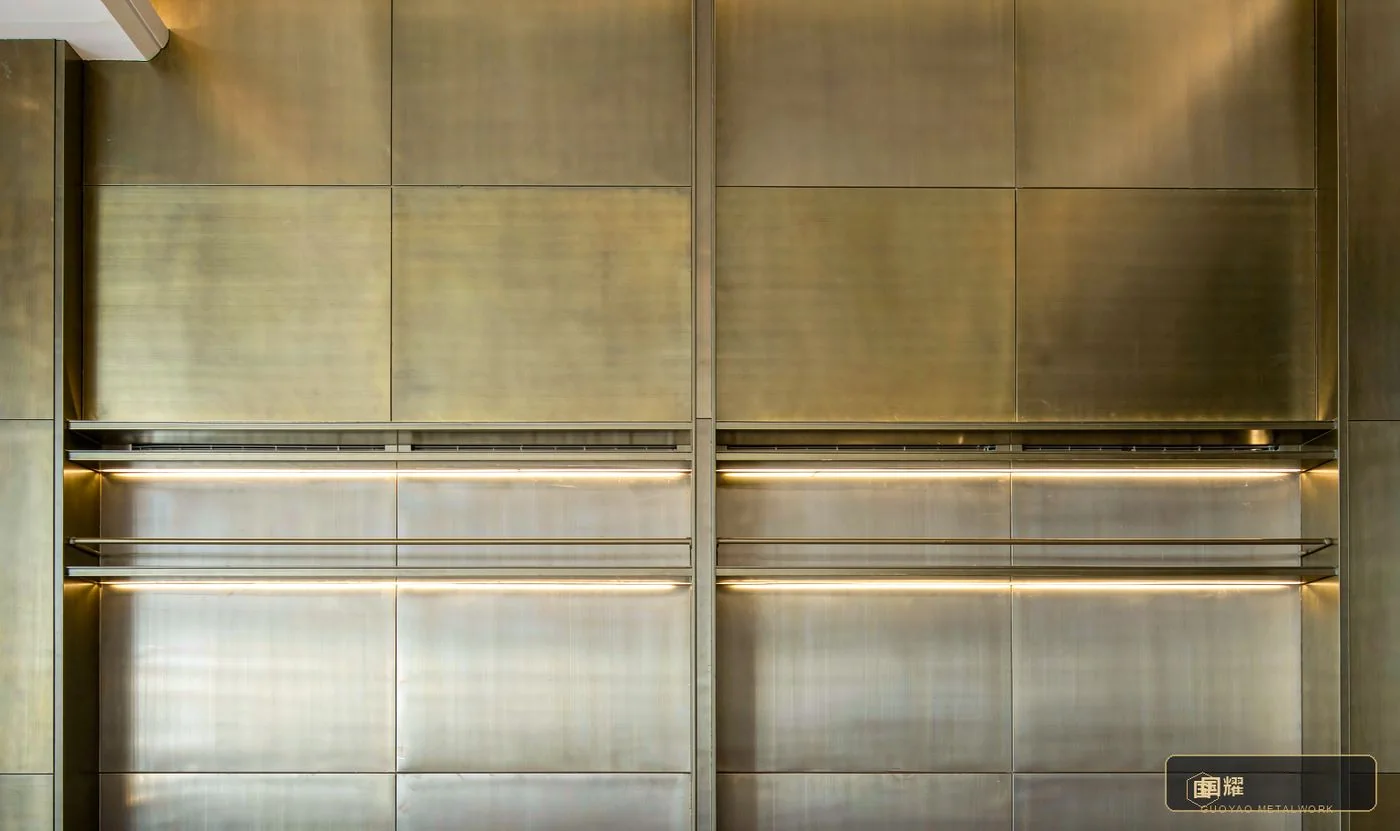 A completed architectural metalwork feature wall — the carrier of the cost structure