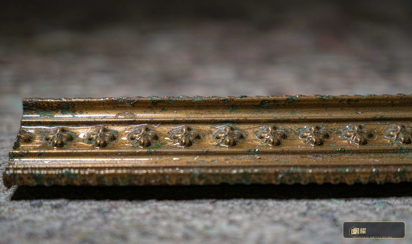 Antique-finish brass close-up: nickel-plated base, antique oxidation and sealing coat