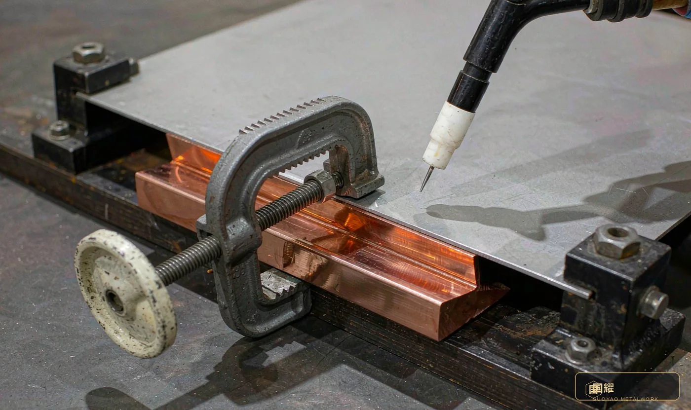 Copper backing and jigs rigidly restraining a sheet weld