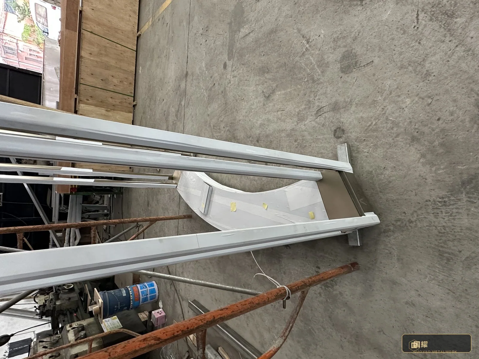 Curved base beam of the pavilion on the workshop floor
