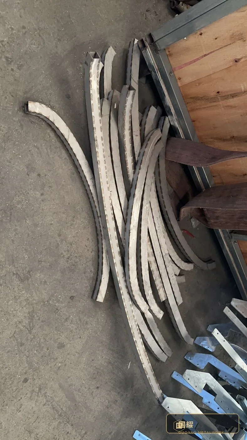Rolled curved strips laid out on the workshop floor