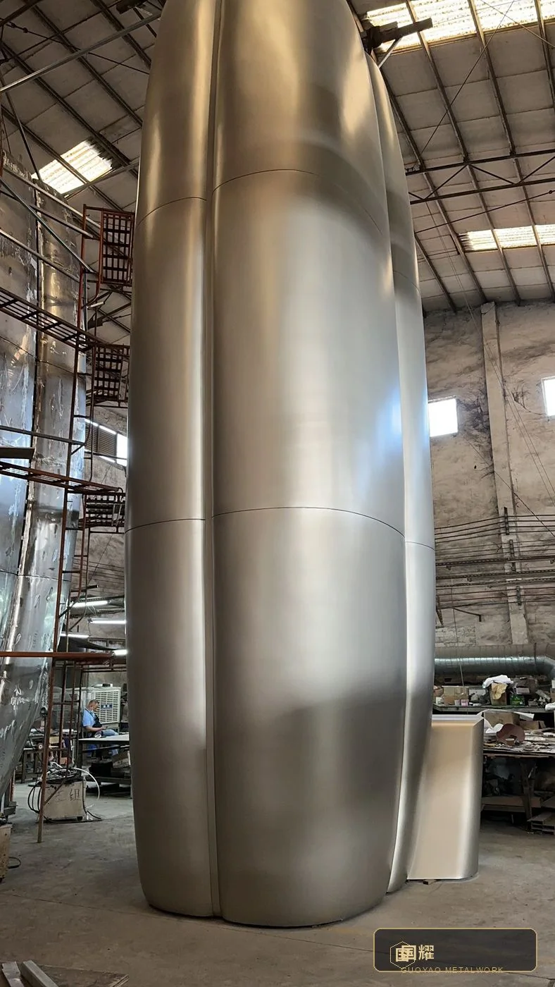 Large curved panel segments standing in the fabrication bay