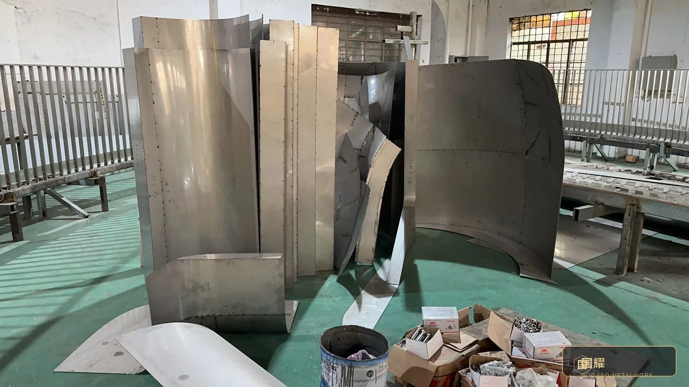 Curved segments staged against the workshop racks