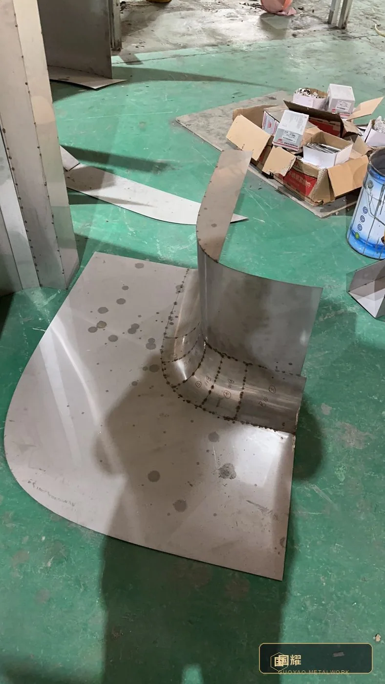 Flat pattern with tack-welded transition piece and setting-out marks