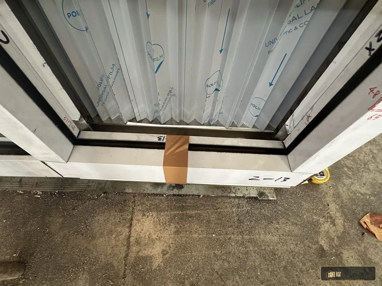 Temporary bracing holding a bay true while alignment shims and fixings are set.