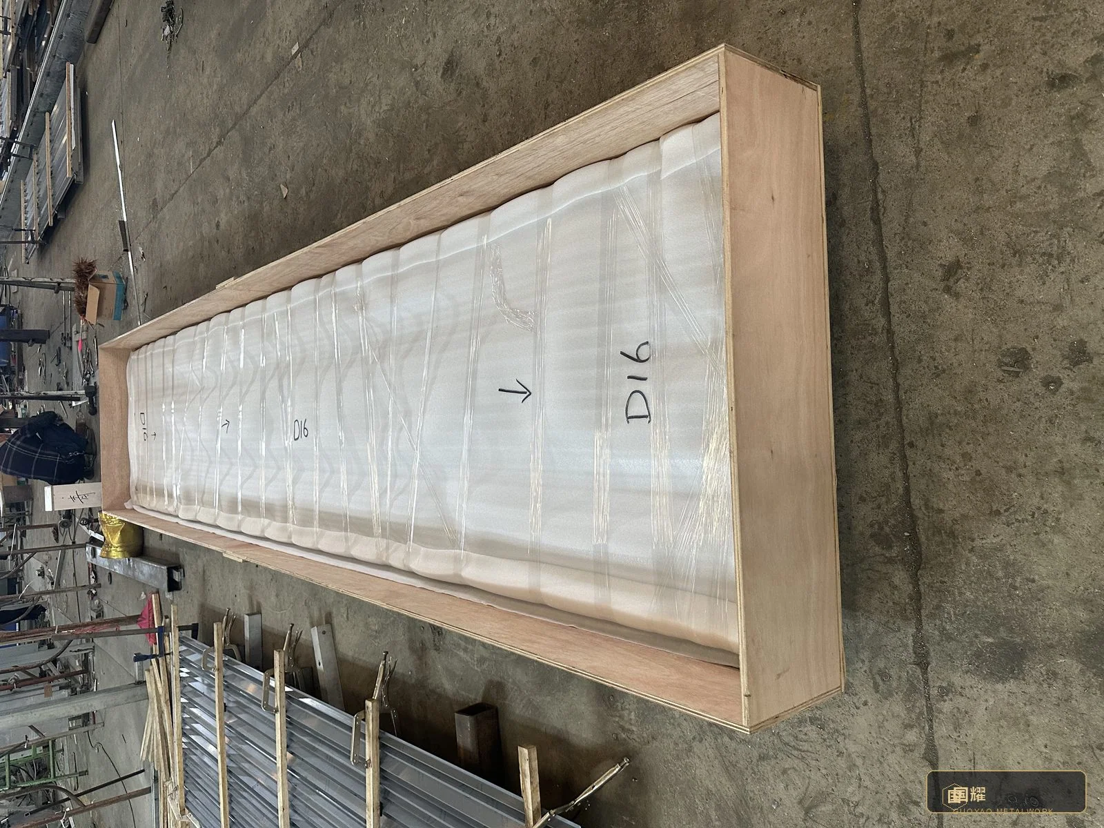 A long fluted panel crate: panels standing on edge in foam-lined partitions — the orientation that protects the flutes for the whole journey.