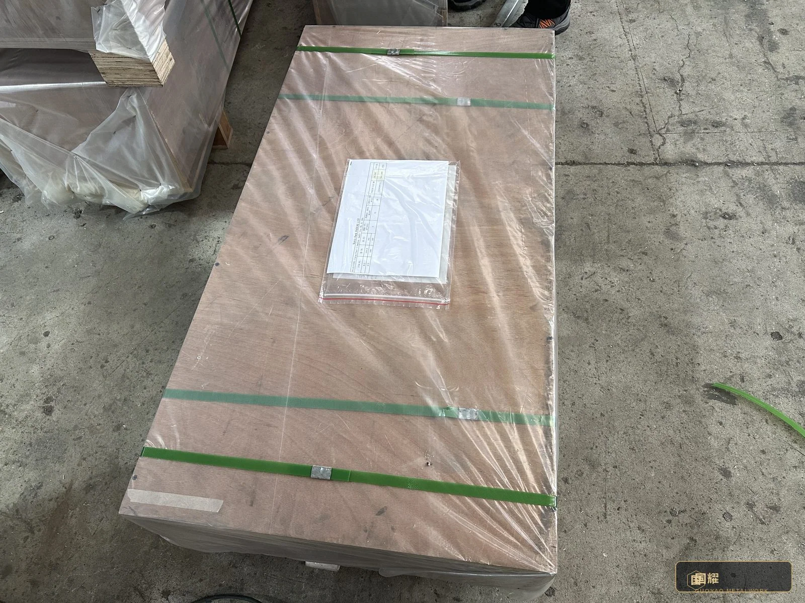 Flat-packed panels braced in their crate, edge protectors and separators doing the quiet work.