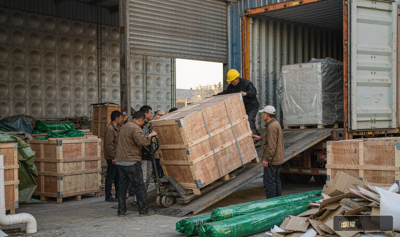 Container loading at the factory: crates guided up the ramp onto a padded deck, braced and blocked to the loading plan.