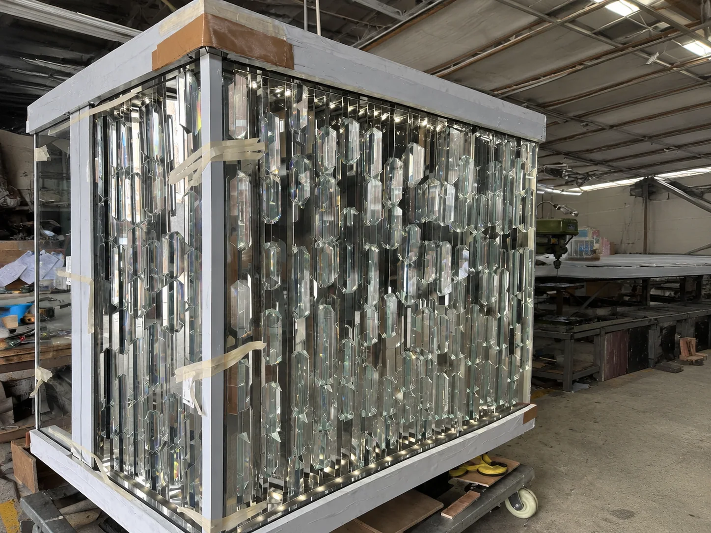 A complete cassette assembly laid out for powered testing — every unit checked for dark spots and connector seating before it can meet a panel.